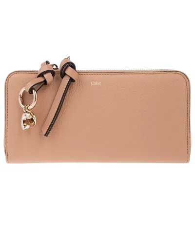 Chloé Logo Charm Zipped Wallet In Leather In Tan