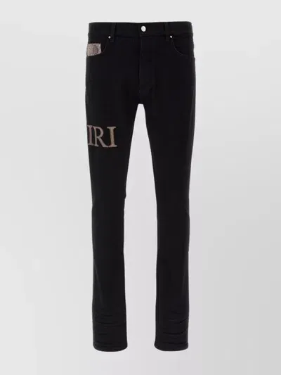 Amiri Snake Logo Distressed Jeans In Black