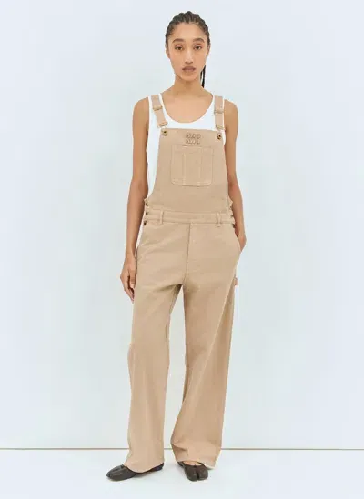 Miu Miu Logo Embossed Overalls In Beige