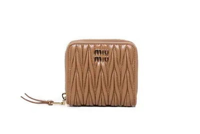 Miu Miu Logo Plaque Zipped Around Wallet In Brown