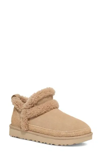 Ugg(r) Classic Ultra Mini Spillseam Genuine Shearling Bootie In Sand