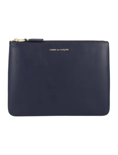 Comme Des Garçons Wallet Logo Embossed Zipped Pouch In Blue